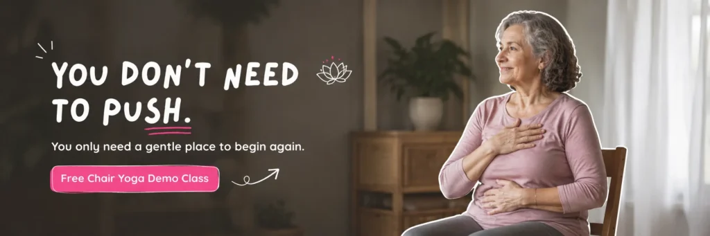 Senior woman practicing mindful Chair Yoga with hands on her heart and abdomen, promoting gentle movement, healing, relaxation, and mind-body connection through Chair Yoga for older adults.